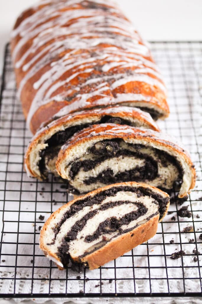 sliced loaf of polish makowiec on a wire rack.