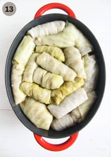 assembling sarmale for cooking in an oval dutch oven.