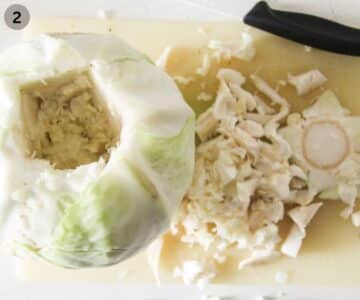 cutting the core out of a whole white cabbage head.