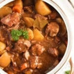 slow cooked lamb casserole with potatoes close up.