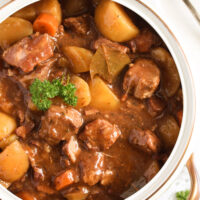 slow cooked lamb casserole with potatoes close up.