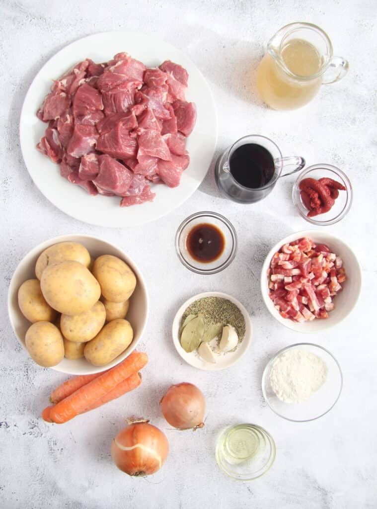 all the ingredients needed for lamb stew on the table.