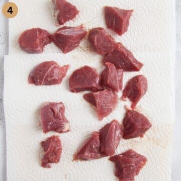 drying lamb cubes on paper towels.