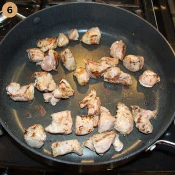 searing lamb pieces in the pan.