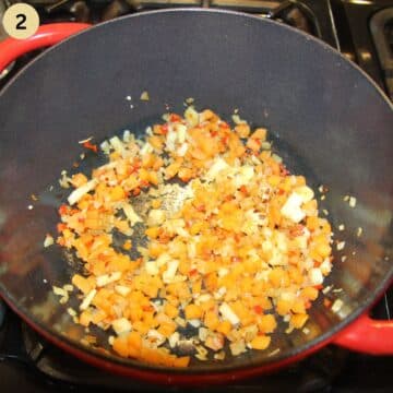 saute vegeatbles for fish stew in a pot.