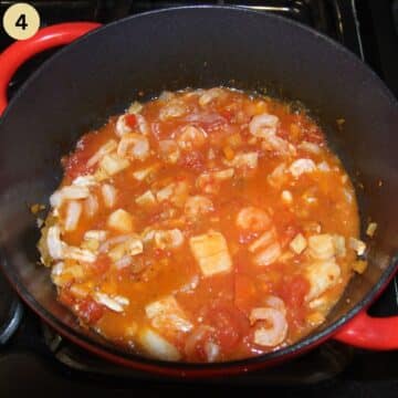 simmering fish stew in a dutch oven.