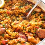 sausage and rice dish with vegetables in a large pot.