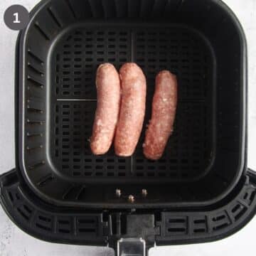 three frozen brats in the air fryer basket.