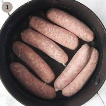 raw sausages in a pan of water.