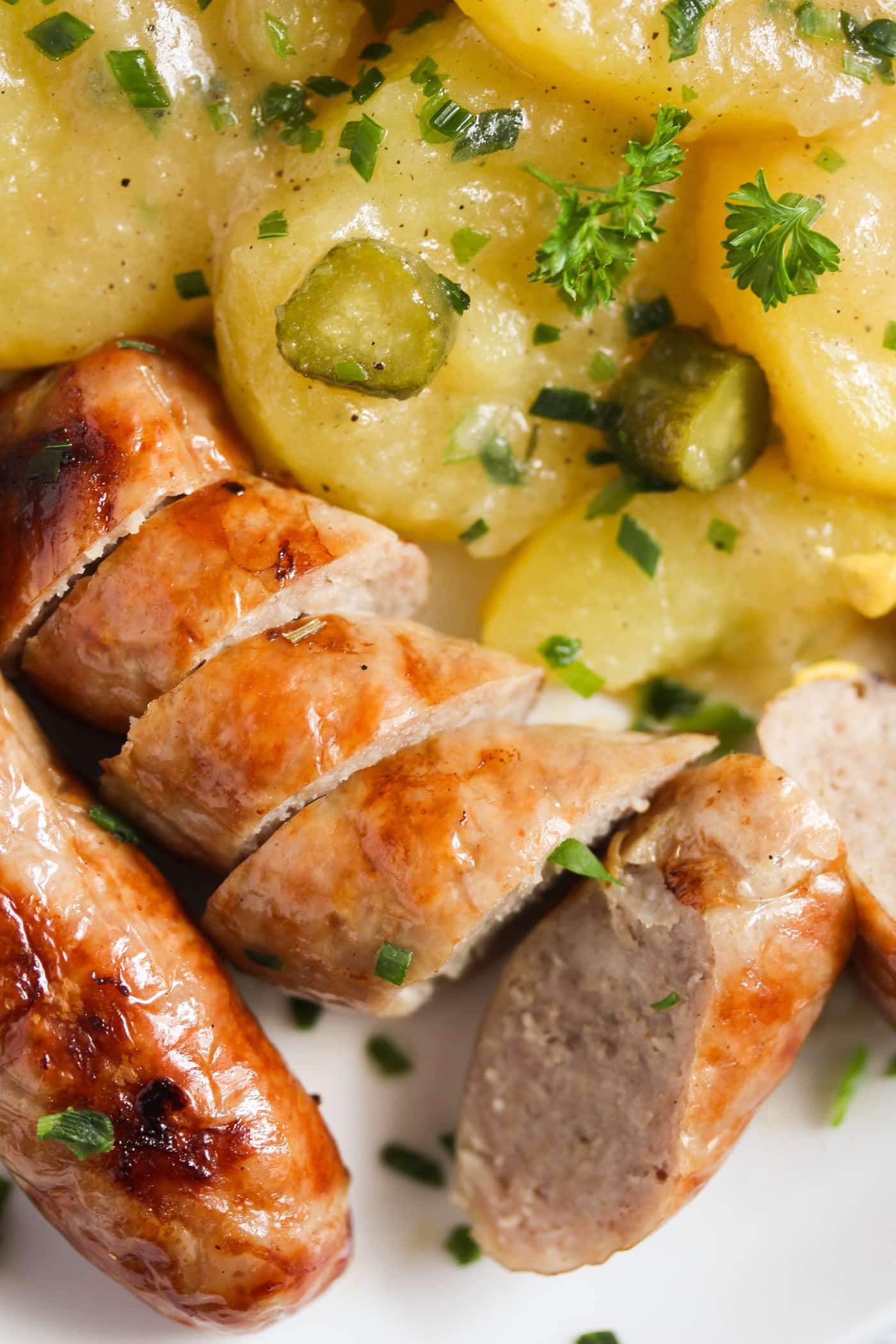 close up bratwurst and potato salad.