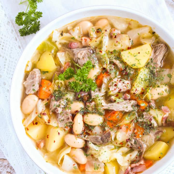 soup made with lamb bone, vegetables and beans in a bowl.