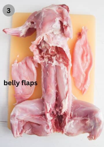 cut up rabbit on a cutting board to show the single pieces.