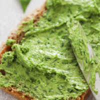 slice of bread slathered with green butter.
