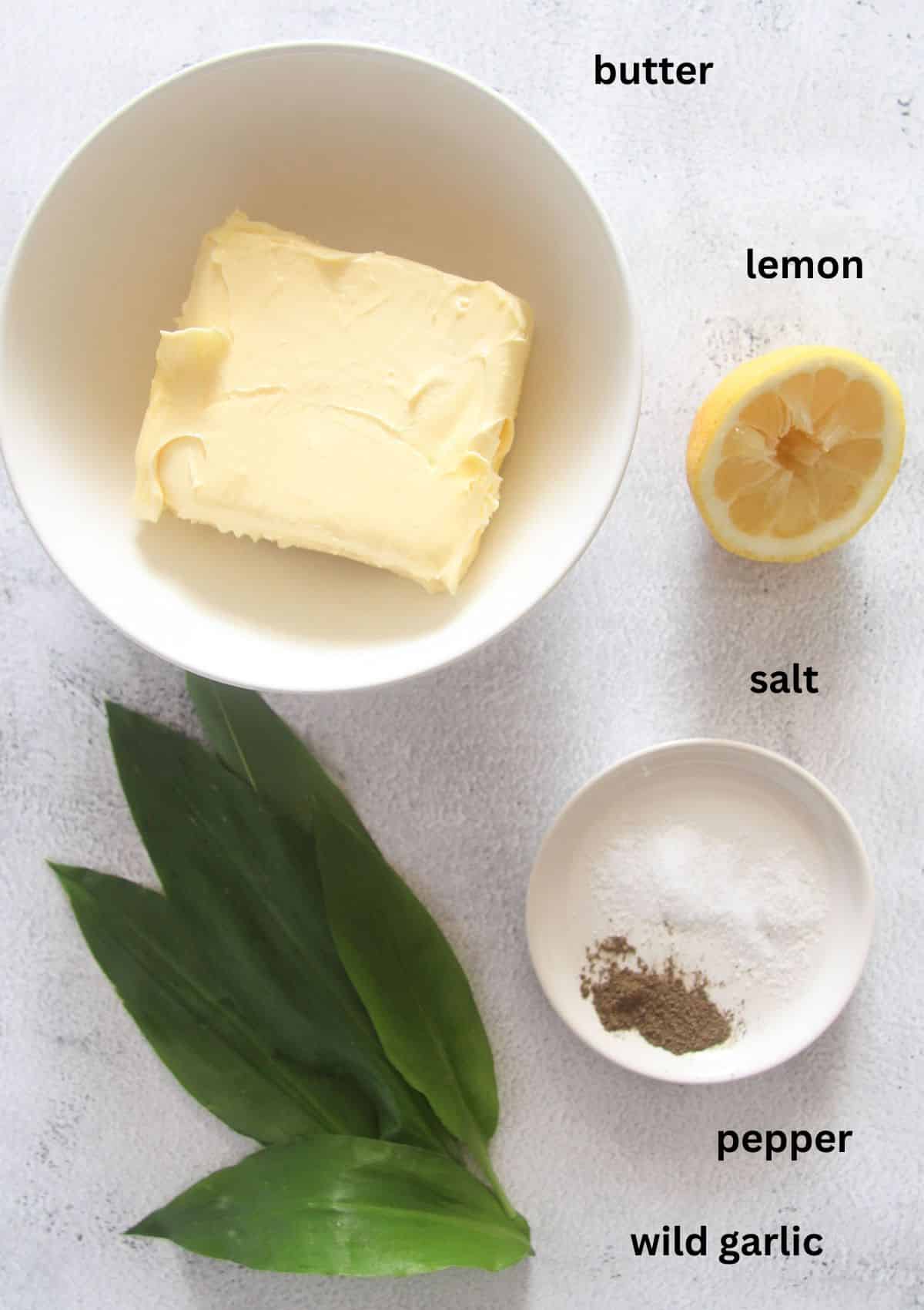 labeled ingredients for making wild garlic butter with lemon, salt and pepper.