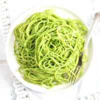 wild garlic pasta on a white plate overhead view.