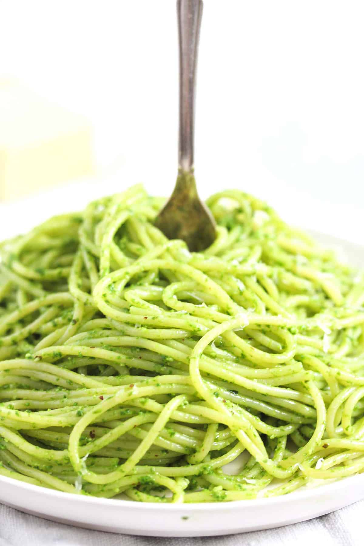 a pile of wild garlic pasta with a fork sticking into it.