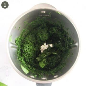 blended ingredients for making wild garlic pesto with parmesan and almonds in a food processor.