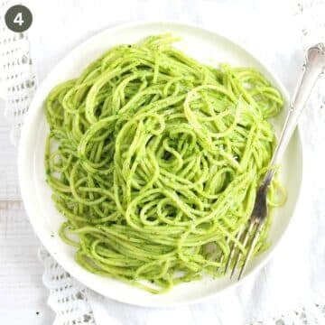 a plate of spaghetti with wild garlic pesto on a plate with a fork.