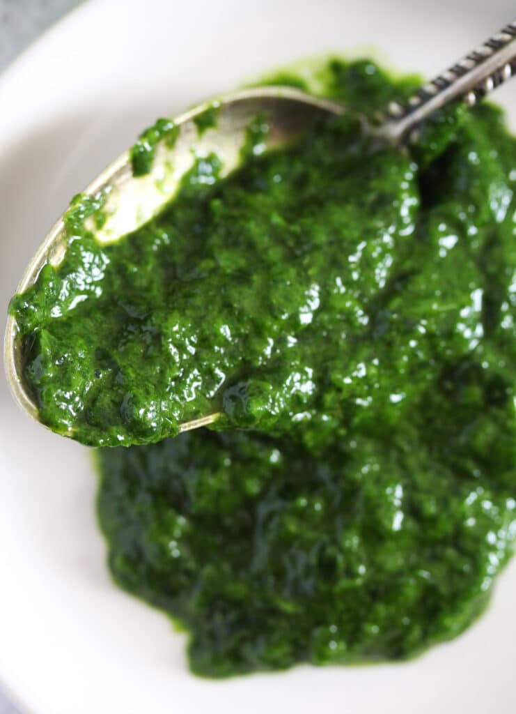 close up of green and shiny ramsons paste for cooking.