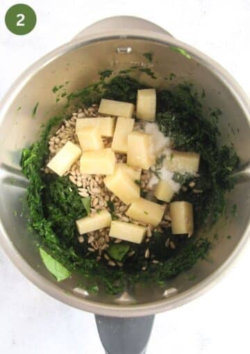chopped wild garlic, cubed parmesan, sunflower seeds, salt and oil in a food processor to make pesto.