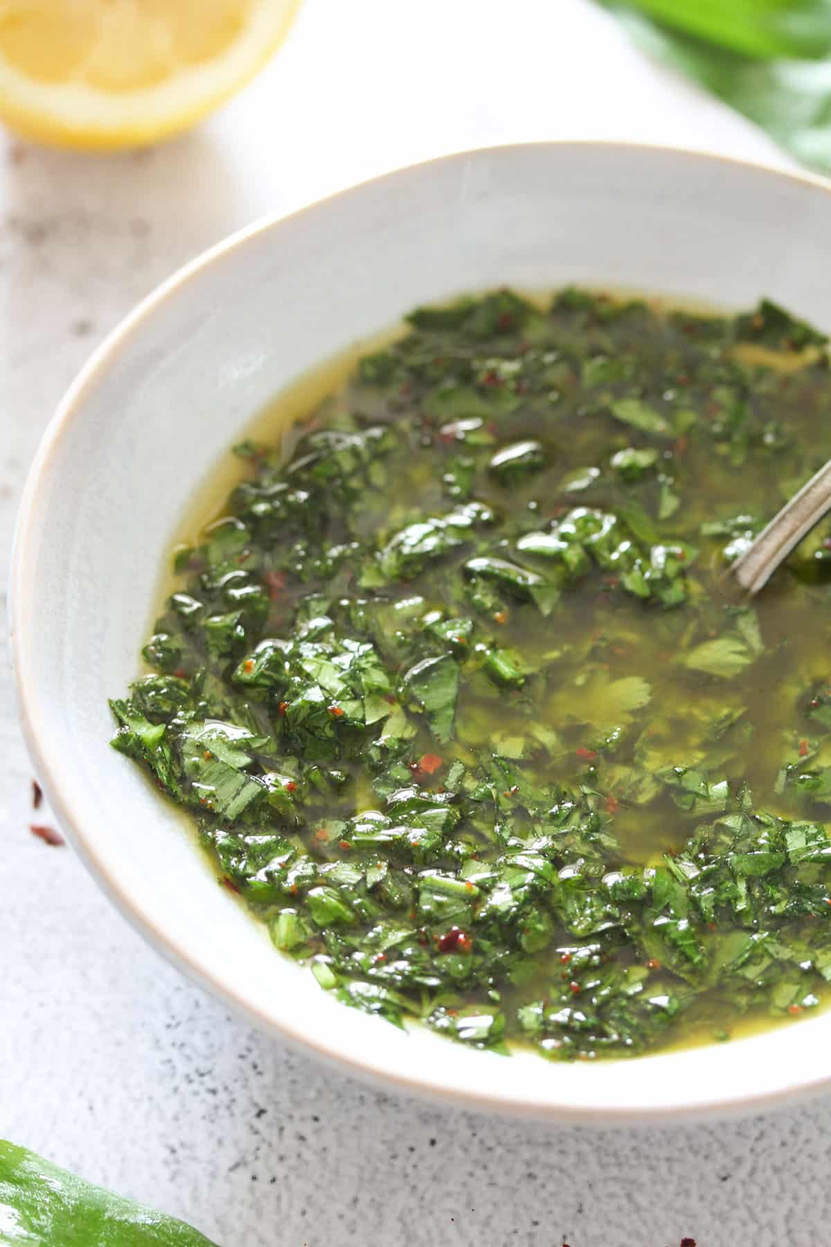 shiny wild garlic sauce with olive oil in a small bowl.
