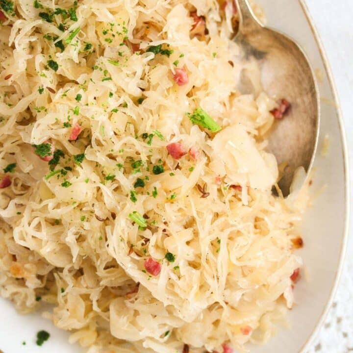 a large plate with bavarian sauerkraut and a spoon.