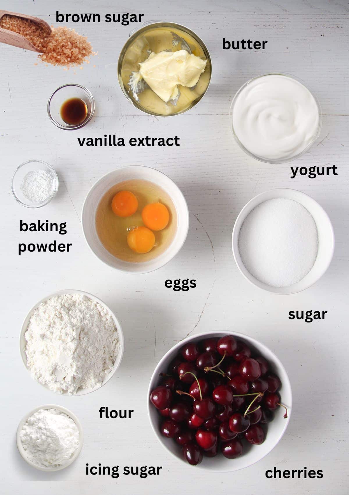 labeled ingredients for making a loaf cake with fresh cherries and yogurt.