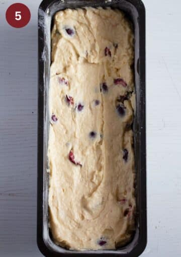 unbaked cherry cake batter in a loaf tin.