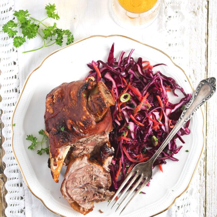 sliced pork hock on a white plate.