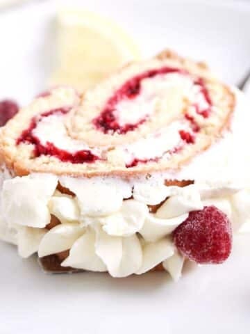 slice of raspberry roulade on a plate.