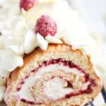pinterest image of swiss roll with raspberries.
