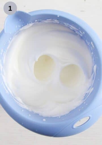 beaten egg whites in a blue bowl.