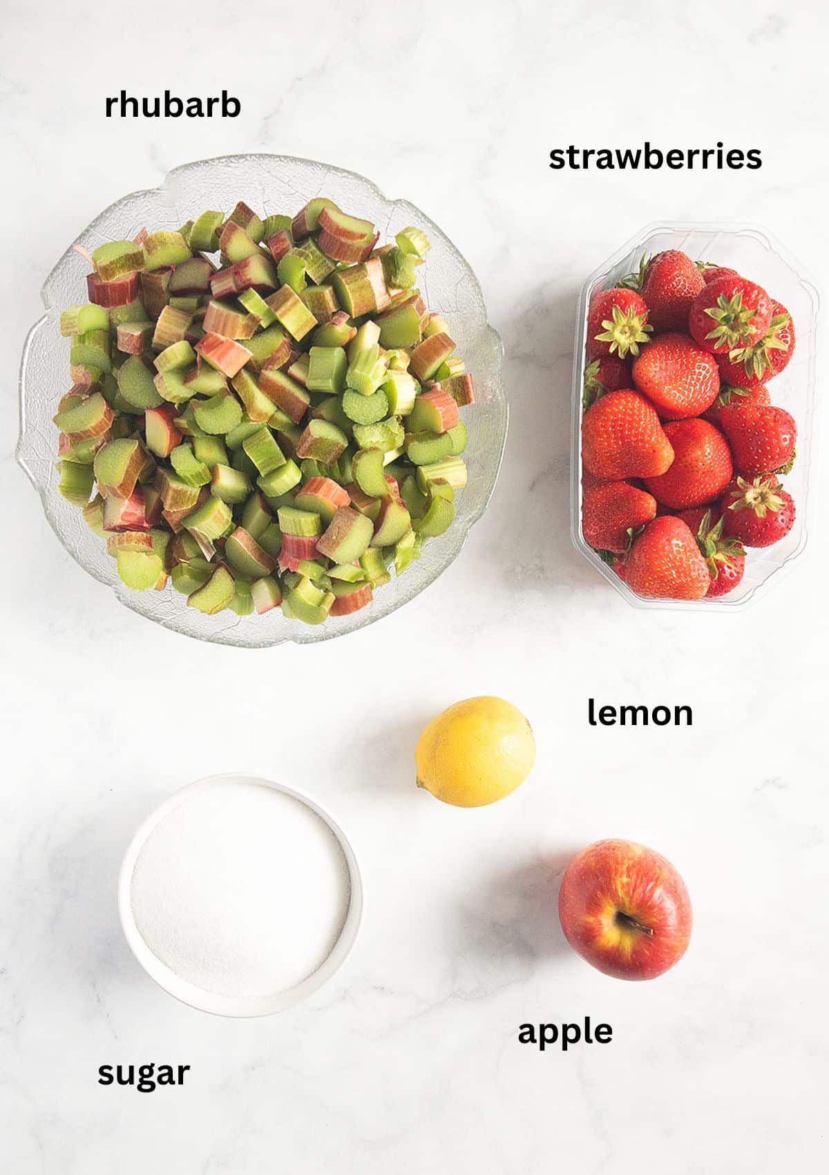 labeled ingredients for making rhubarb and strawberry jam with sugar, lemon and apple.