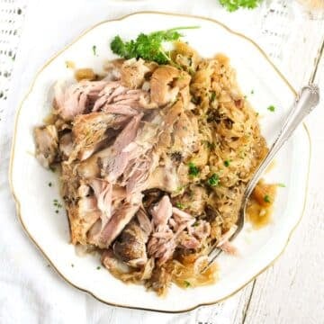 plate with slow cooked pork hocks served with sauerkraut.