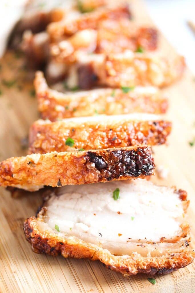 pork belly slices on a wooden board.