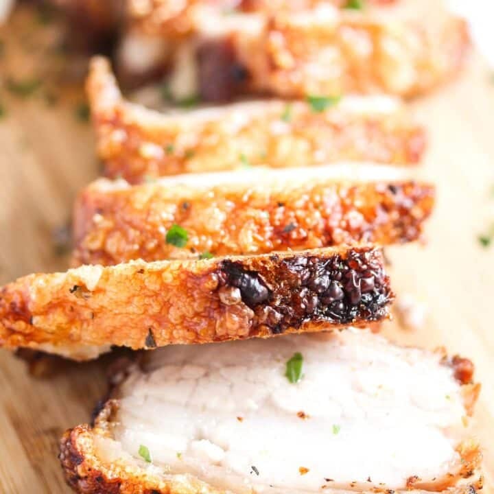 pork belly slices on a wooden board.