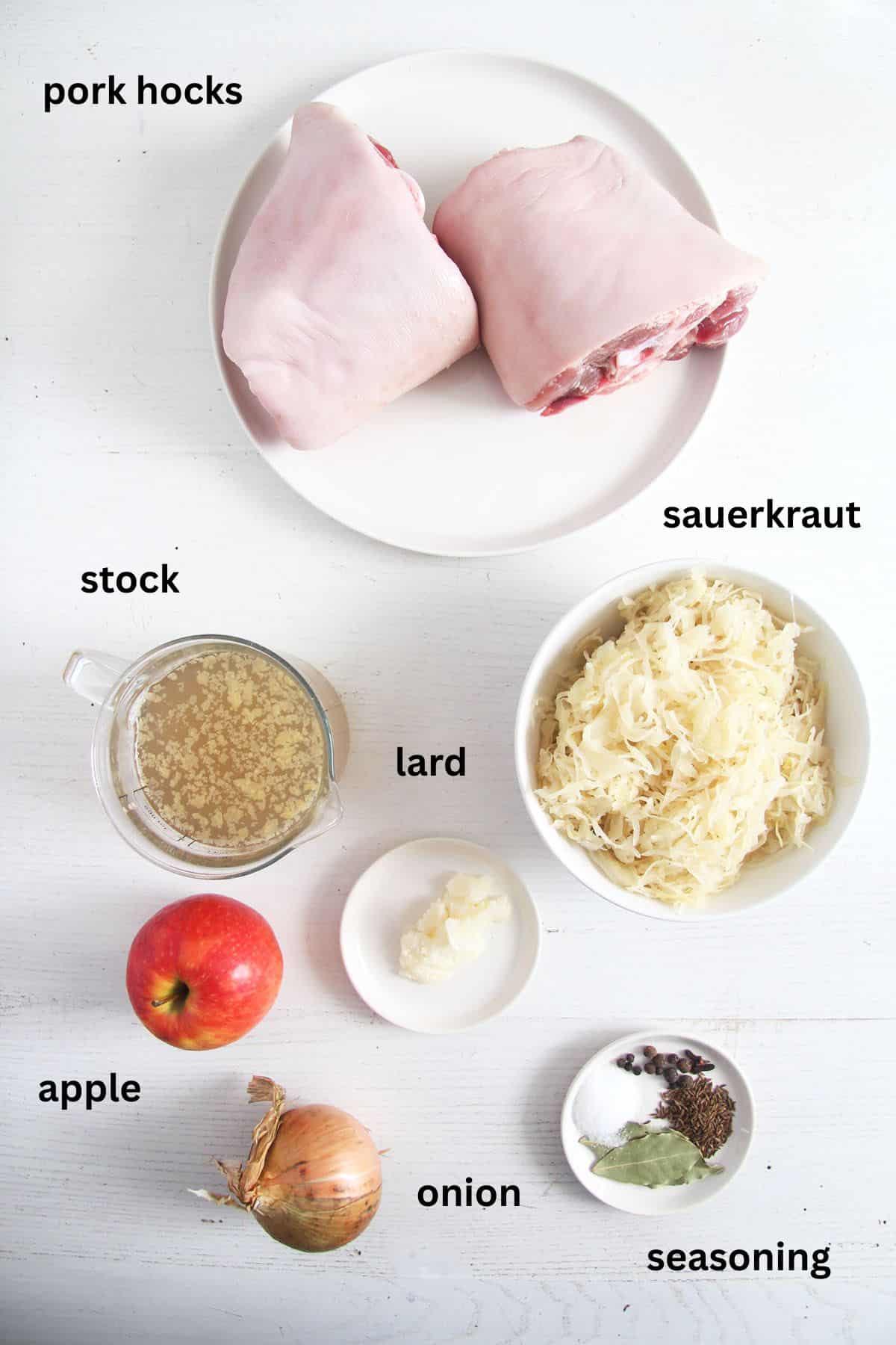 labeled ingredients for making pork hocks with sauerkraut in the slow cooker.