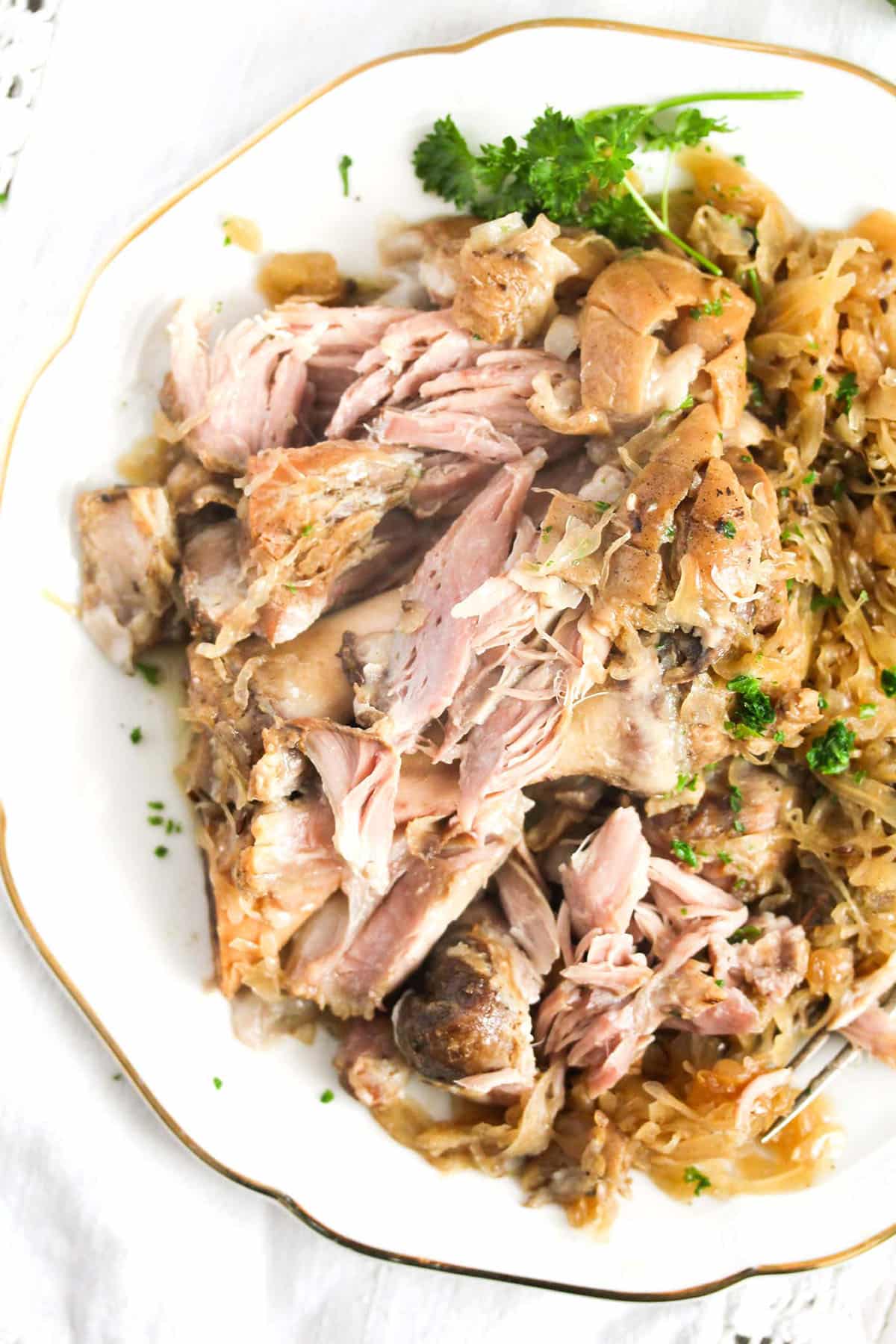 slow cooked pork hocks with sauerkraut on a plate.