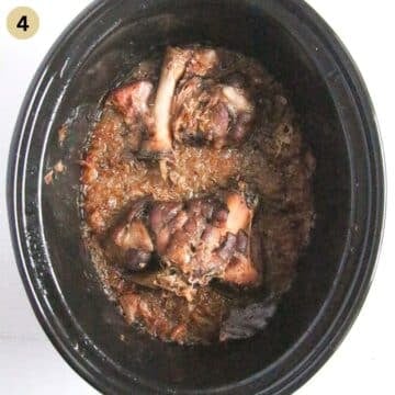 pork hocks and sauerkraut in a slow cooker after cooking.