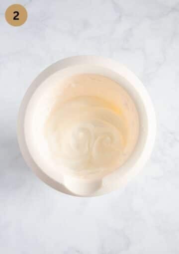 beaten egg whites for cake in a bowl.