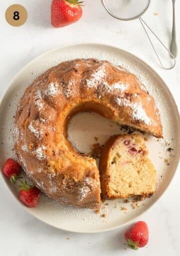bundt cake with rhubarb and strawberries on a plate.