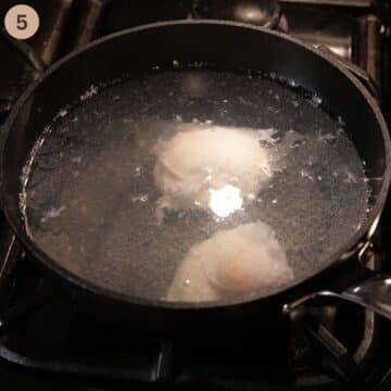 poaching two eggs in a pot full of water.