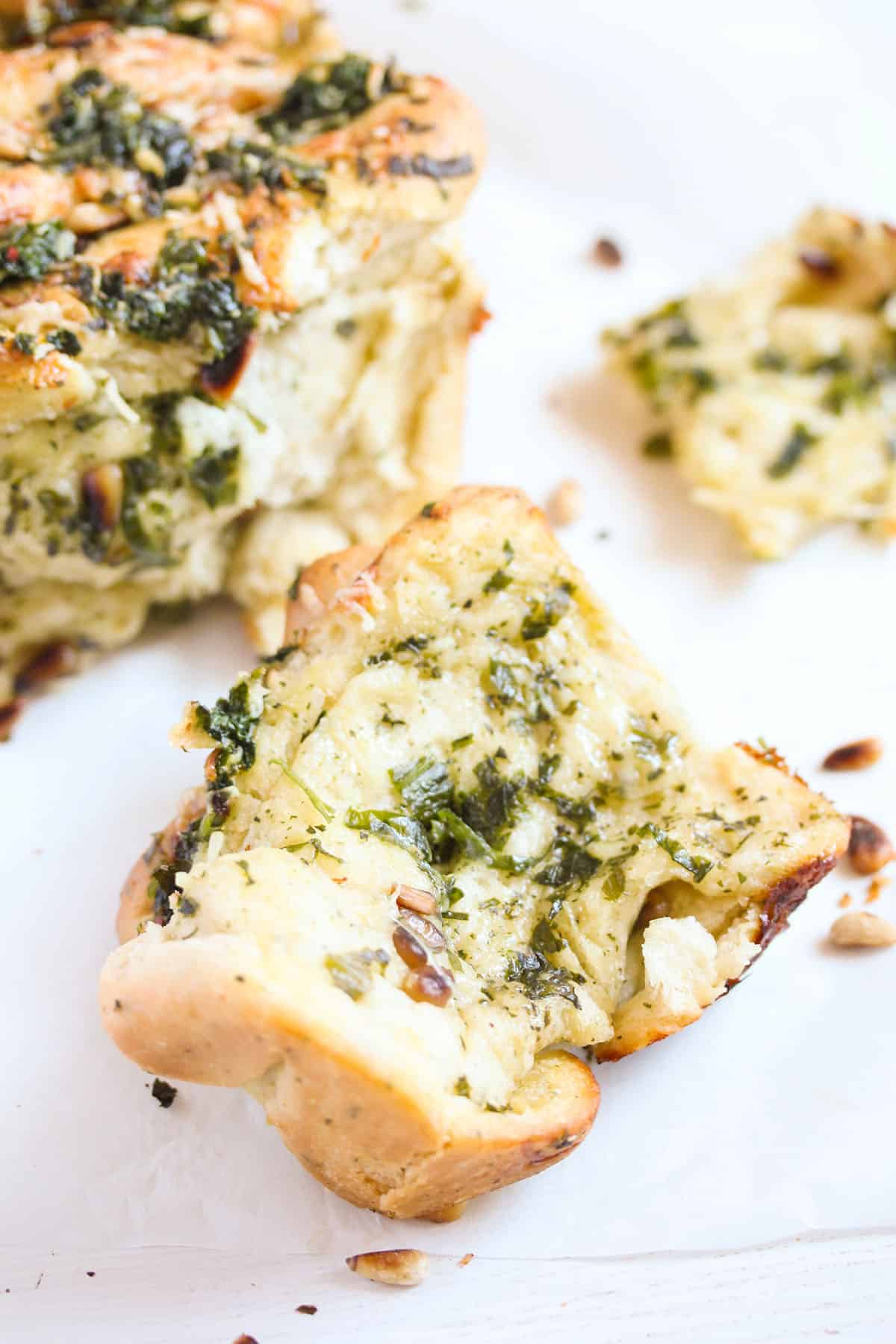 one slice torn from pull apart wild garlic bread.