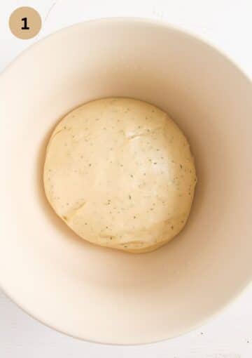 wild garlic bread dough in a bowl before rising.