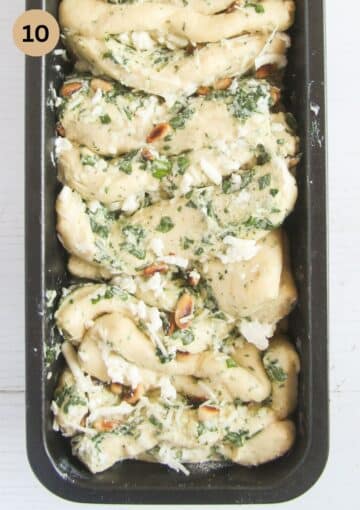 unbaked pull apart bread with wild garlic in a pan.