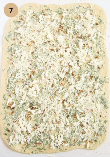 piece of dough spread with wild garlic and cheese filling.
