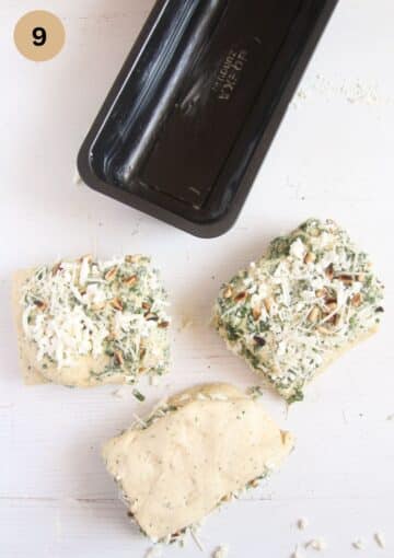 cut pieces of dough for stapling wild garlic pull apart bread in a loaf pan.