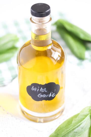 a small, labeled bottle containing homemade wild garlic oil.