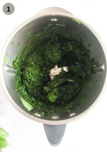 chopped wild garlic in a food processor for making flavored salt.