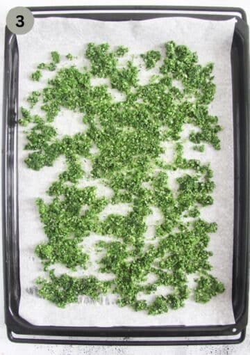 wild garlic salt drying on a baking sheet lined with parchment paper.